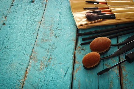 Set of professional makeup brushes on wooden table.の写真素材