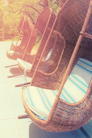 Photo of comfortable swings. Summer travel and vacation concept. Vintage filtered imageの写真素材