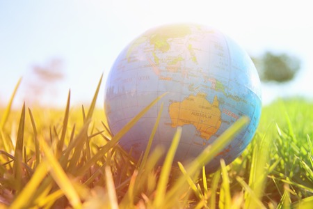 low angle small globe in the grass. travel and global issues concept.の写真素材