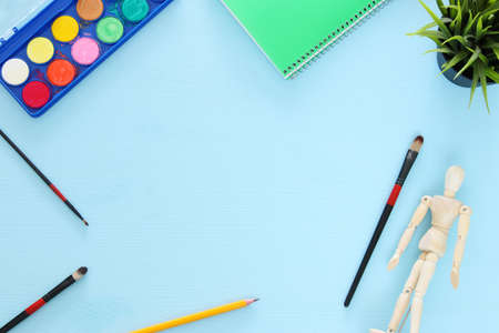 Top view of artist art supplies background. Copy space
