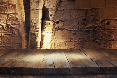 Empty old table in front of ancient knight stone tower. Useful for product display montage.の写真素材