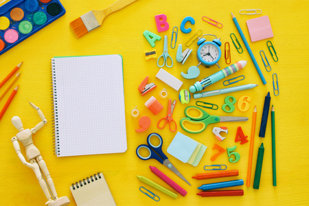 Back to school concept. Top view. School notebook on yellow wooden background.の写真素材