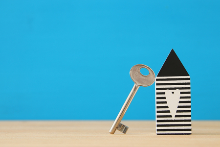 small house model with key over wooden floor. selective focus.の写真素材