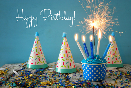 Birthday concept with cupcake and candles on wooden tableの写真素材