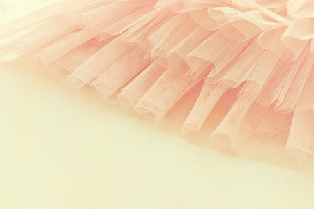 Vintage tulle pink chiffon dress on wooden white table. Wedding and girl's party concept.の写真素材