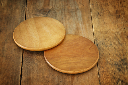 image of wooden beer coasters on textured table background.の写真素材