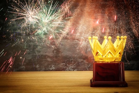 image of golden crown award over wooden table. Glitter overlayの写真素材