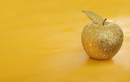 Rosh hashanah (jewish New Year holiday) concept. Decorative gold glitter apple.の写真素材