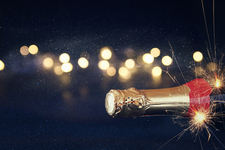 Abstract image of champagne bottle and festive lights. New year and celebration conceptの写真素材