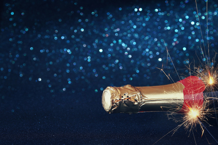 image of champagne bottle and festive lights. New year and celebration conceptの写真素材