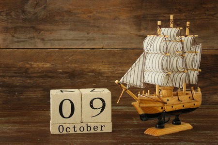 Columbus day concept with old ship over wooden background.の写真素材
