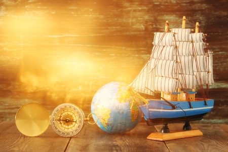 Columbus day concept with old ship over wooden background.の写真素材