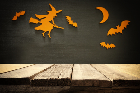 Halloween holiday concept. Empty rustic table in front of spider web, witch and bats background. Ready for product display montageの写真素材