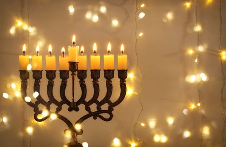 Low key image of jewish holiday Hanukkah background with menorah (traditional candelabra) and burning candlesの写真素材