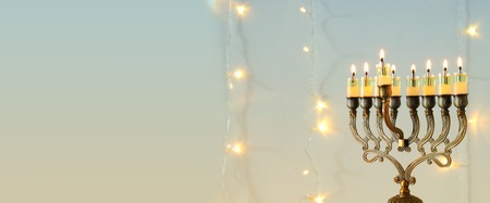 image of jewish holiday Hanukkah background with menorah (traditional candelabra) and burning candlesの写真素材