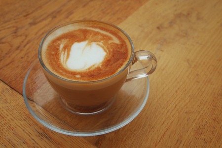 image of coffee cup over old wooden table.の写真素材