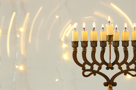 image of jewish holiday Hanukkah background with menorah (traditional candelabra) and burning candlesの写真素材