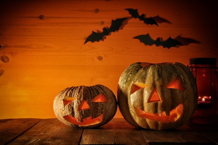 Halloween Pumpkin on wooden table in front of spooky dark background. Jack o lantern.の写真素材