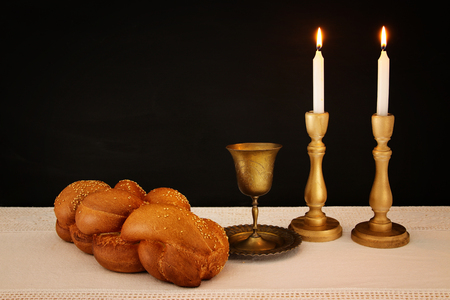 shabbat image. challah bread, shabbat wine and candles on the table.の写真素材