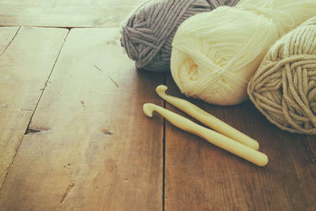 warm and cozy yarn balls of wool on wooden table.の写真素材