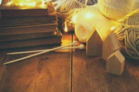 warm and cozy yarn balls of wool on wooden tableの写真素材