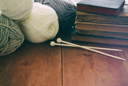 warm and cozy yarn balls of wool on wooden table