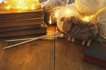 warm and cozy yarn balls of wool on wooden tableの写真素材