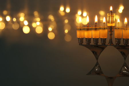 image of jewish holiday Hanukkah background with menorah (traditional candelabra) and burning candlesの写真素材