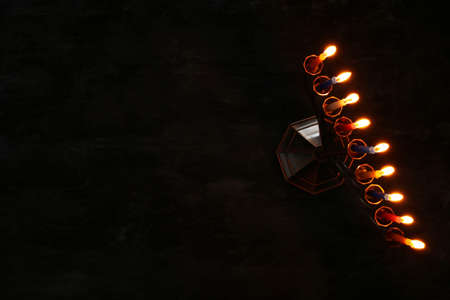 image of jewish holiday Hanukkah background with menorah (traditional candelabra) and burning candlesの写真素材