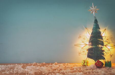 Image of christmas trees on snowy wooden tableの写真素材