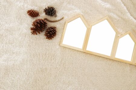 Empty houses shape wooden photo frames over cozy and warm fur carpet. For photography montage. Scandinavian style design. Top viewの写真素材