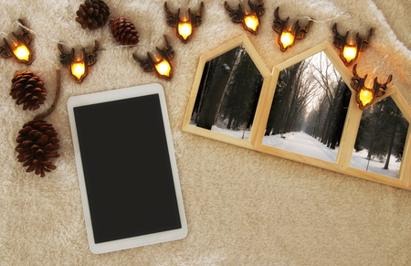 Houses shape wooden photo frames over cozy and warm fur carpet. Scandinavian style design. Top viewの写真素材