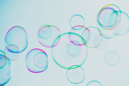Soap bubbles floating in the air against soft clouds and sky. selective focus image