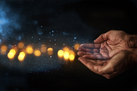 closeup hands of elderly man begging for help. concept for poverty or hunger or seeking for light in the dark