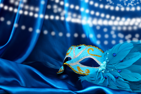Image of elegant venetian mask over blue silk backgroundの写真素材