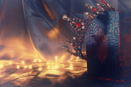 low key image of beautiful queen/king crown on old book. fantasy medieval periodの写真素材
