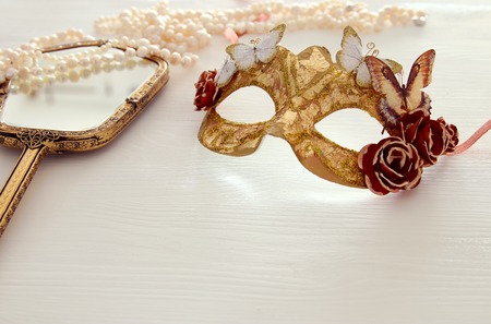 Image of delicate blue elegant venetian mask over wooden white backgroundの写真素材