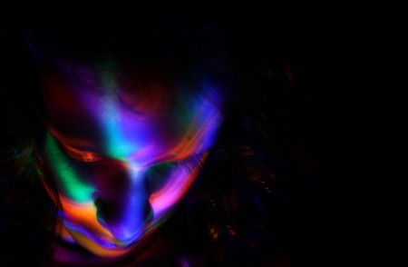 abstract portrait of young girl under colorful fluorescent Neon dark lights, enigmatic styleの写真素材