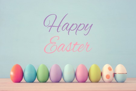 Top view of easter colorful eggs over blue background.