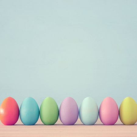 Top view of easter colorful eggs over blue background.