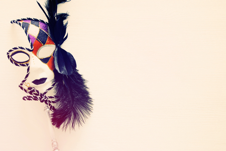 Top view image of dramatic masquerade venetian mask over white background. Flat lay. vintage filteredの写真素材