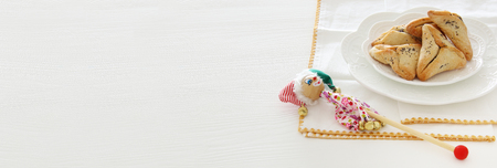 Purim celebration concept (jewish carnival holiday). Traditional hamantaschen cookies over white tableの写真素材