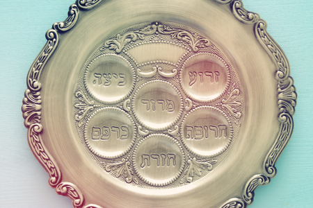 Pesah celebration concept (jewish Passover holiday). Traditional pesah plate text in hebrew: Passover, horseradish, celery, egg, bone, maror, charosetの写真素材