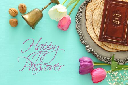 Pesah celebration concept (jewish Passover holiday). Traditional book with text in hebrew: Passover...