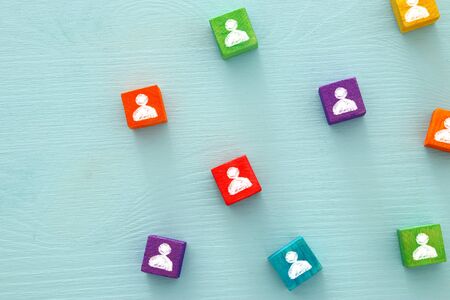 image of colorful blocks with people icons over wooden table ,human resources and management concept