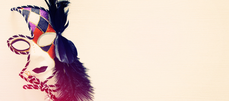 Top view image of dramatic masquerade venetian mask over white background. Flat lay. vintage filteredの写真素材