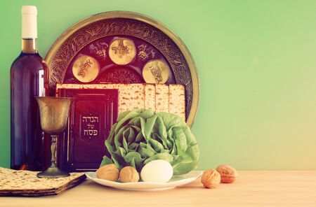 Pesah celebration concept (jewish Passover holiday). Traditional book with text in hebrew: Passover...