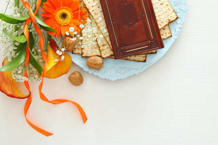 Pesah celebration concept (jewish Passover holiday). Traditional book with text in hebrew: Passover...