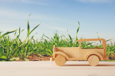 Vintage wooden toy car over wooden table. Nostalgia and simplicity conceptの写真素材