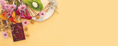 Pesah celebration concept (jewish Passover holiday). Traditional book with text in hebrew: Passover...